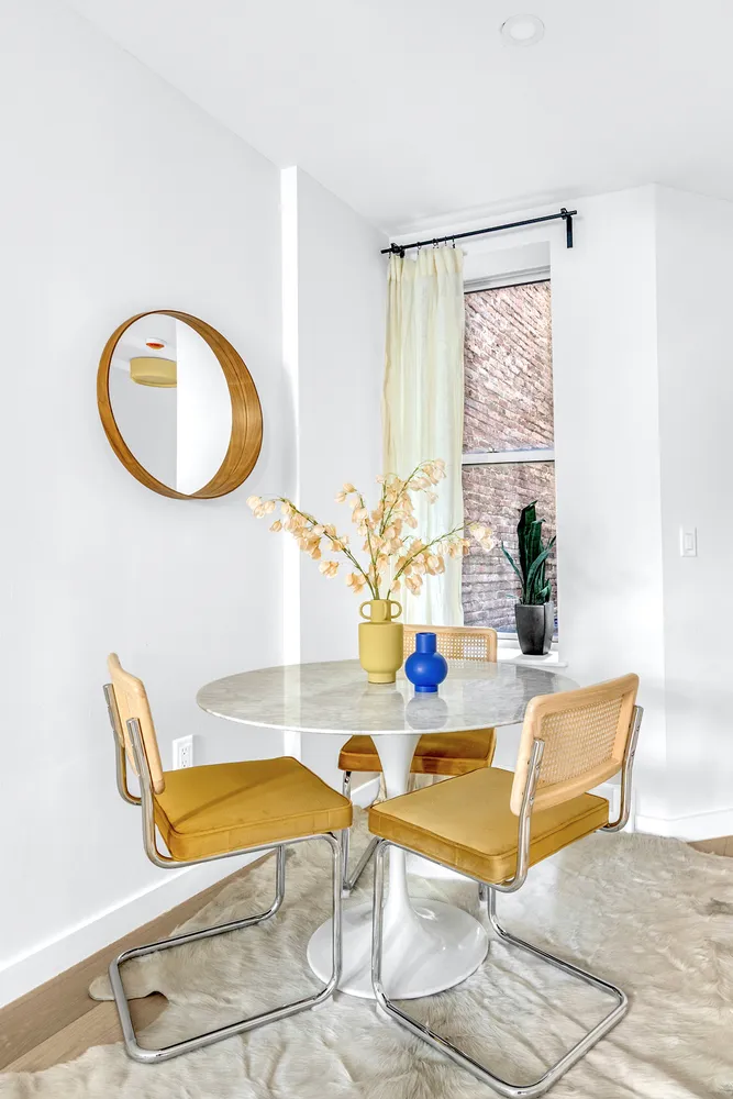 a dining room with table and chairs