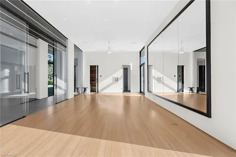 a view of a living room with wooden floor and a large window