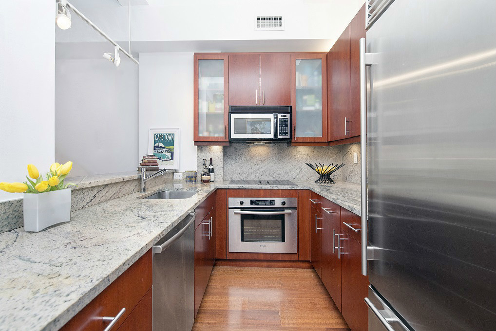 80 John Street, Unit 11E Manhattan, NY 10038 - Photo 5 of 9 a kitchen with stainless steel appliances granite countertop a sink stove and refrigerator