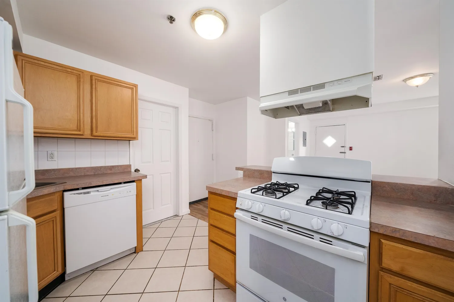 a kitchen with granite countertop cabinets and a stove top oven