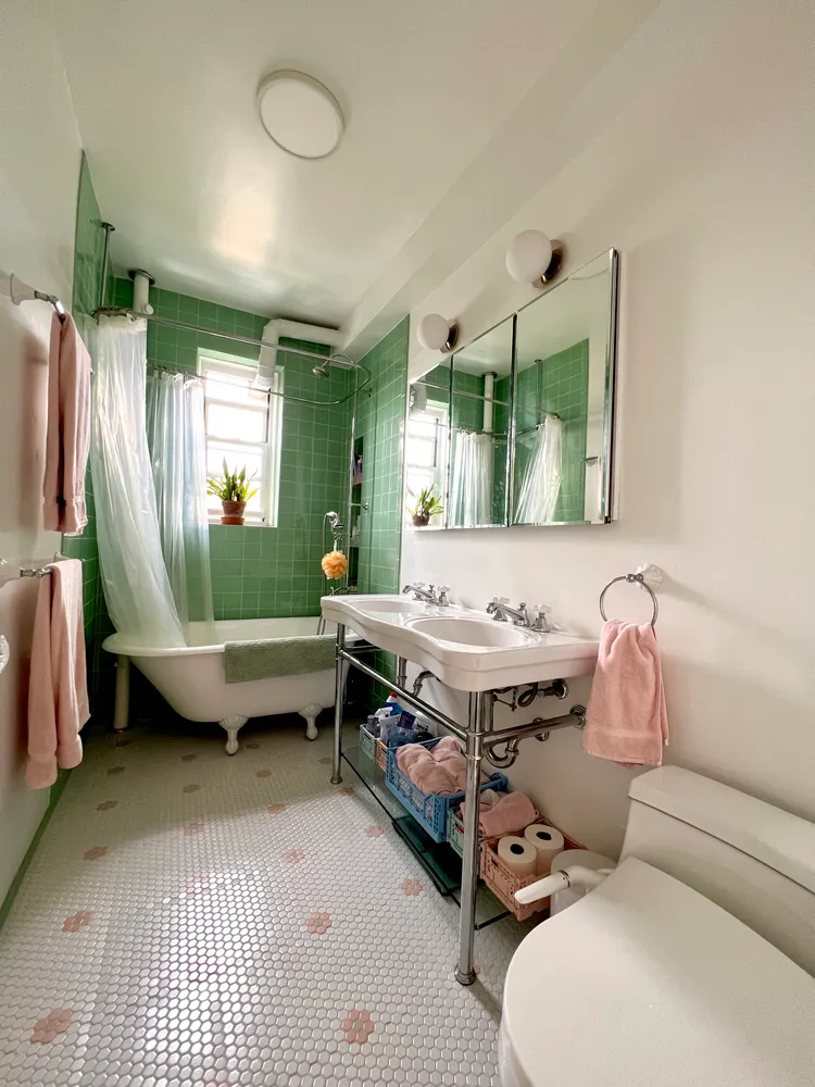 a bathroom with a sink mirror and a bathtub
