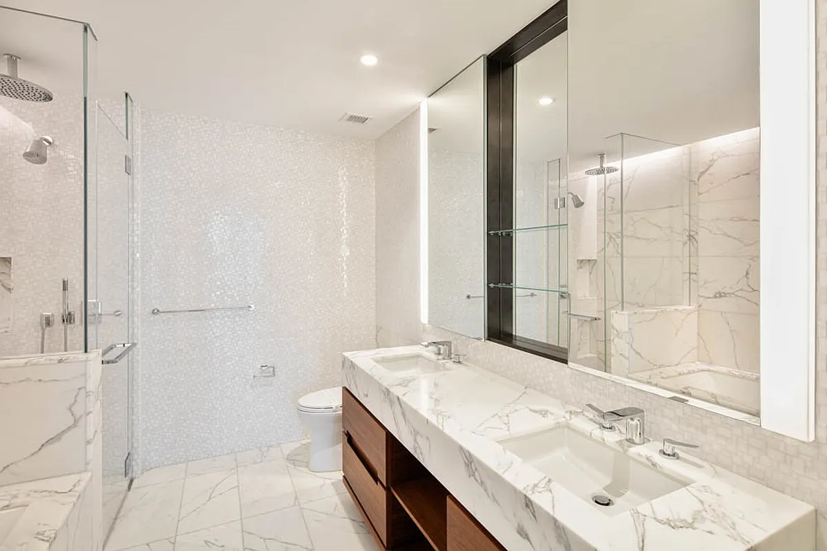 30 Riverside Boulevard, Unit 23L Manhattan, NY 10069 - Photo 5 of 23 a bathroom with a granite countertop sink mirror and shower