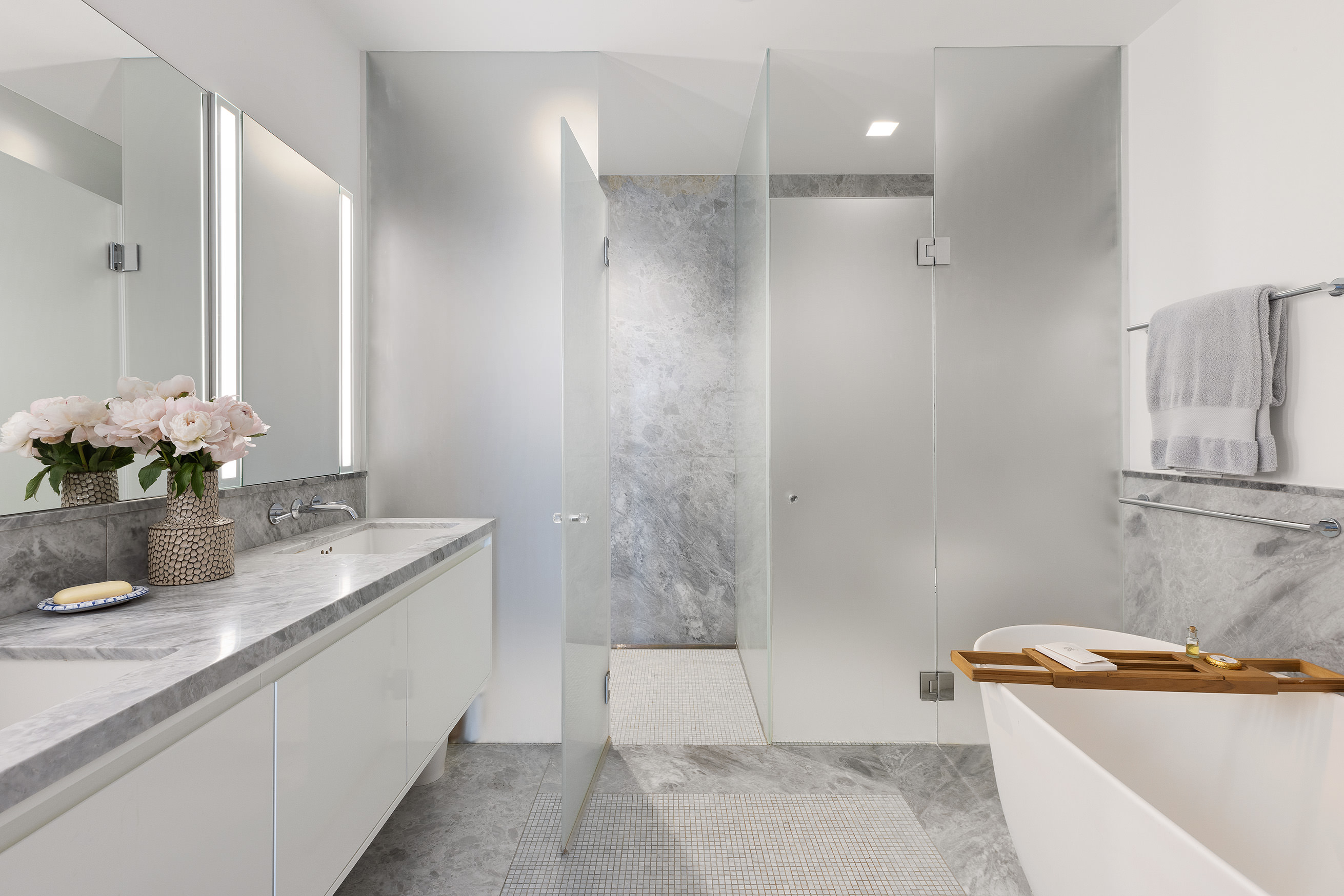 21 East 12th Street, Unit 17B Manhattan, NY 10003 - Photo 11 of 13 a bathroom with a granite countertop sink and a bathtub