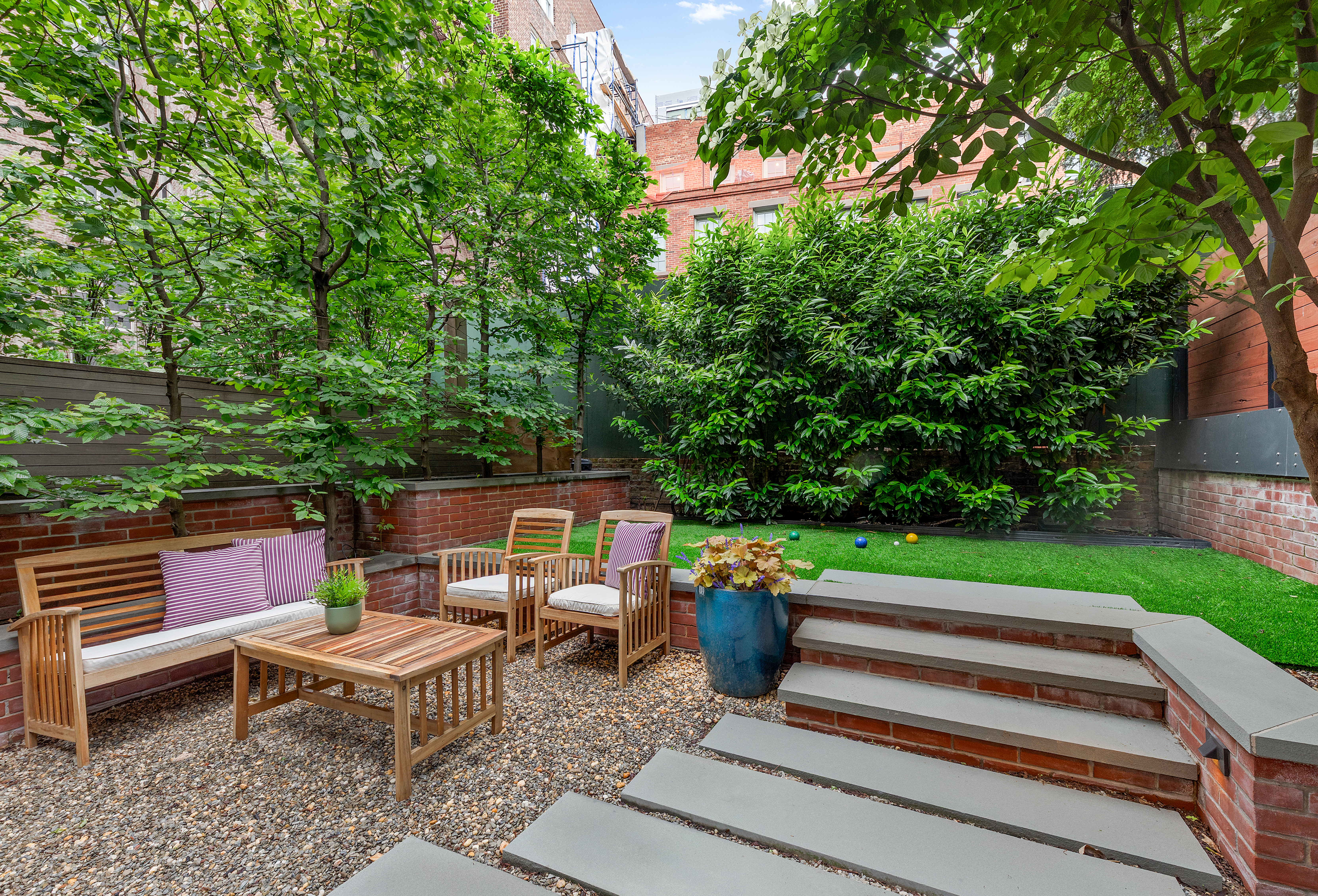 21 Bethune Street, Unit GARDEN Manhattan, NY 10014 - Photo 11 of 12 a backyard of a house with outdoor seating