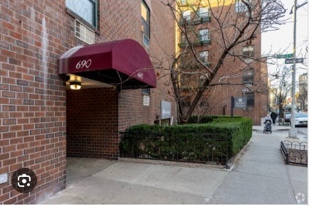 690 Washington Street, Unit 1A Manhattan, NY 10014 - Photo 16 of 17 a front view of a building with parking space