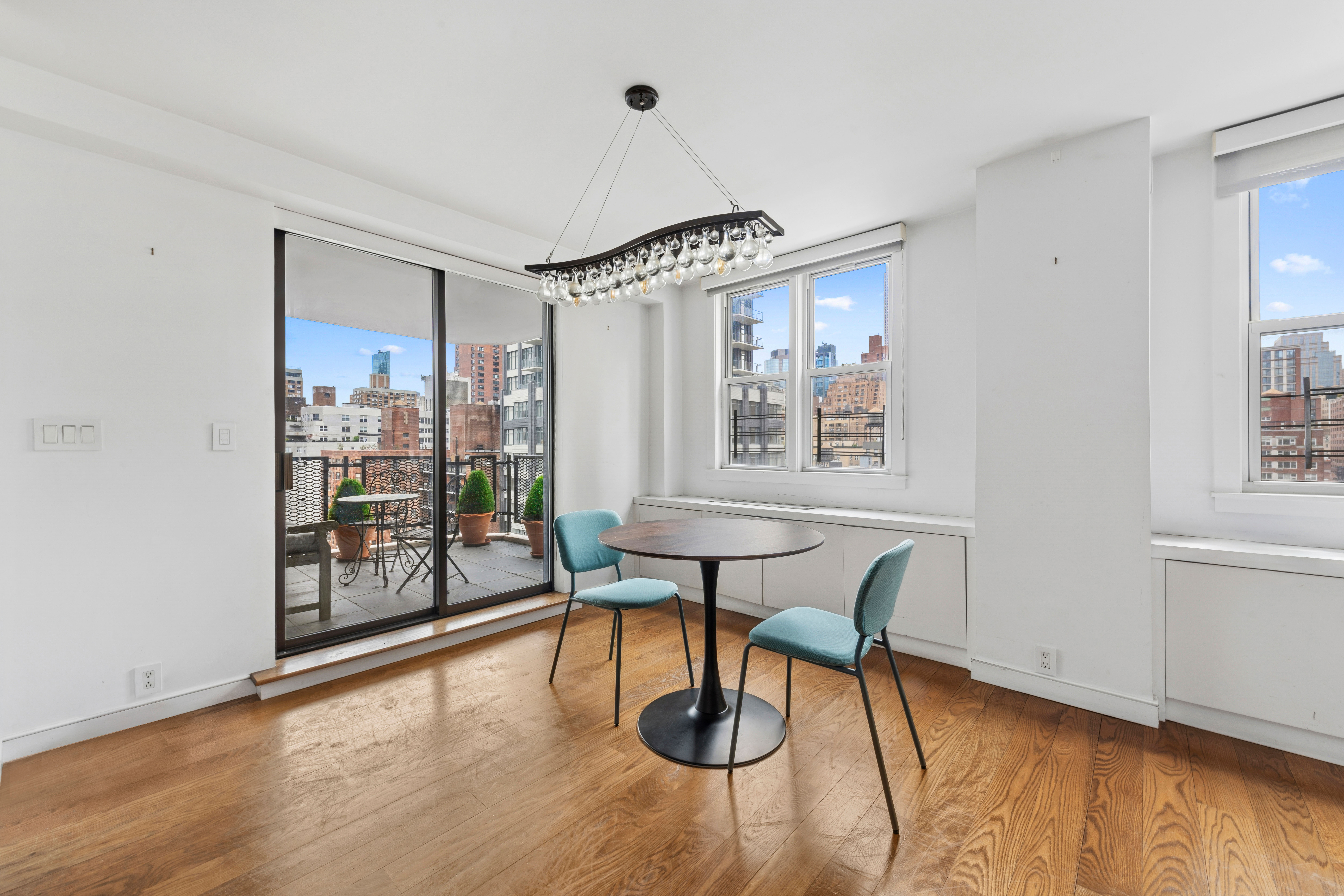 201 East 36th Street, Unit 17C Manhattan, NY 10016 - Photo 3 of 13 a view of a dining room with furniture window and wooden floor