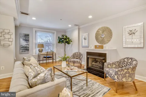 a living room with furniture a fireplace and a table