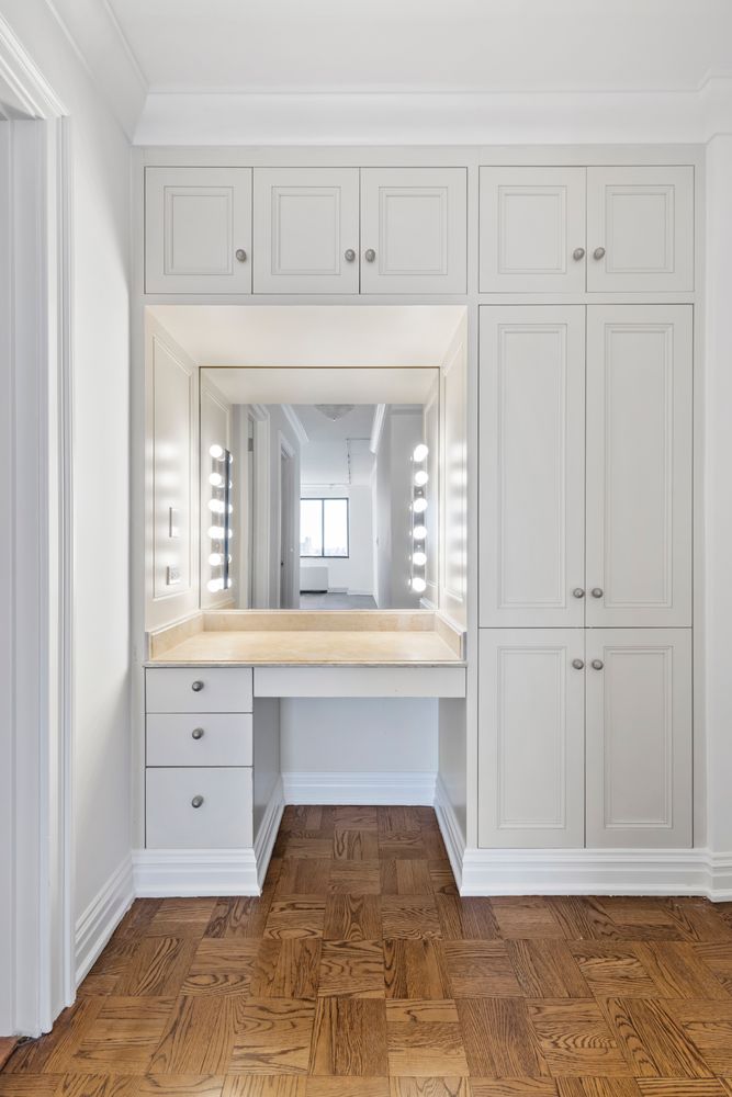 40 East 80th Street, Unit 25A Manhattan, NY 10075 - Photo 14 of 18 a view of a hallway with granite countertop white cabinets and a window
