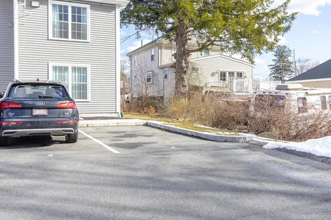 a view of a car parked in front of a house