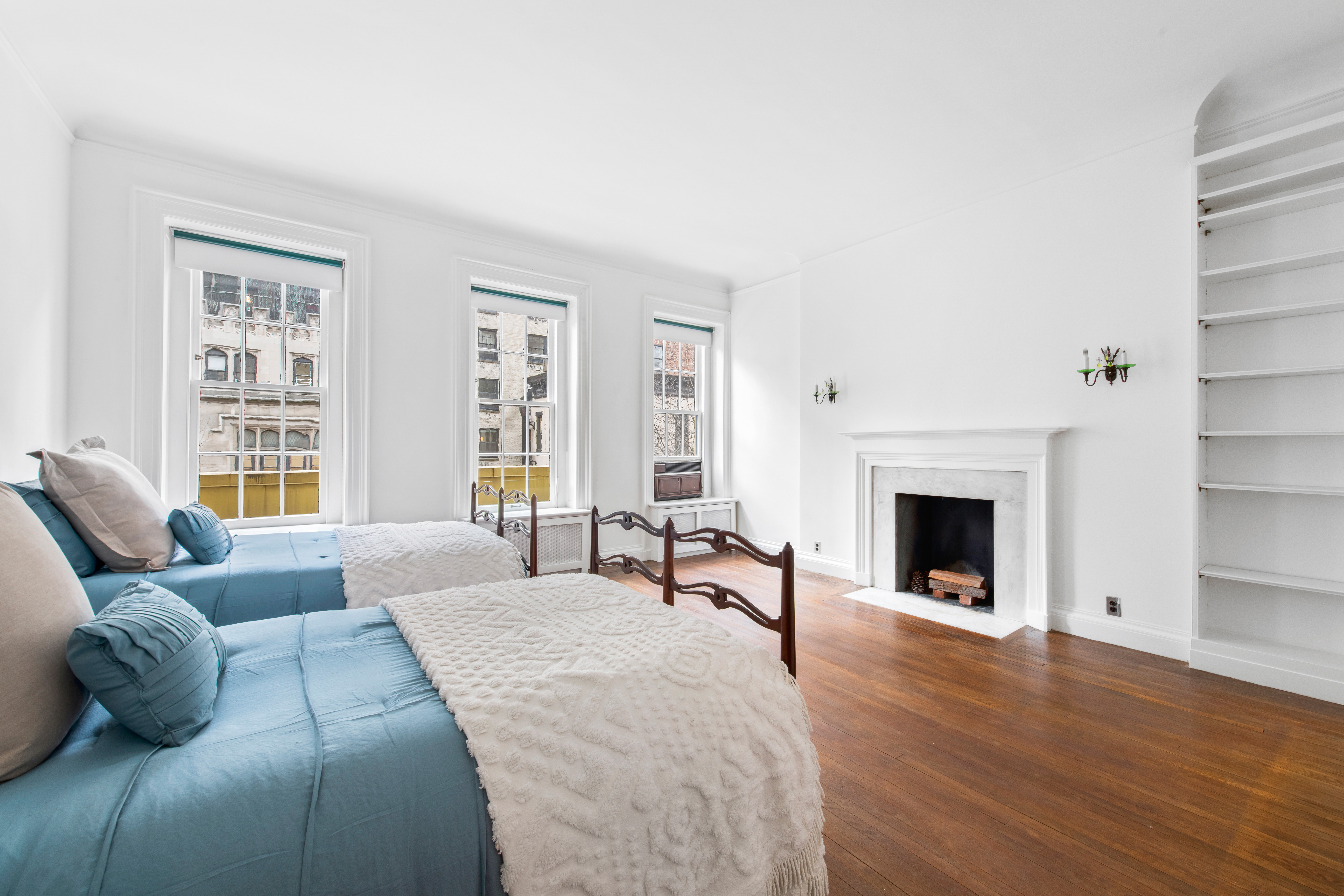155 East 70th Street Manhattan, NY 10021 - Photo 15 of 27 a spacious bedroom with a bed and a couch
