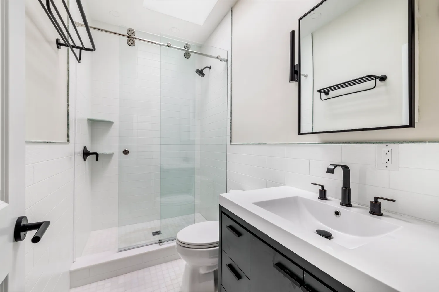 a bathroom with a sink a toilet and a mirror