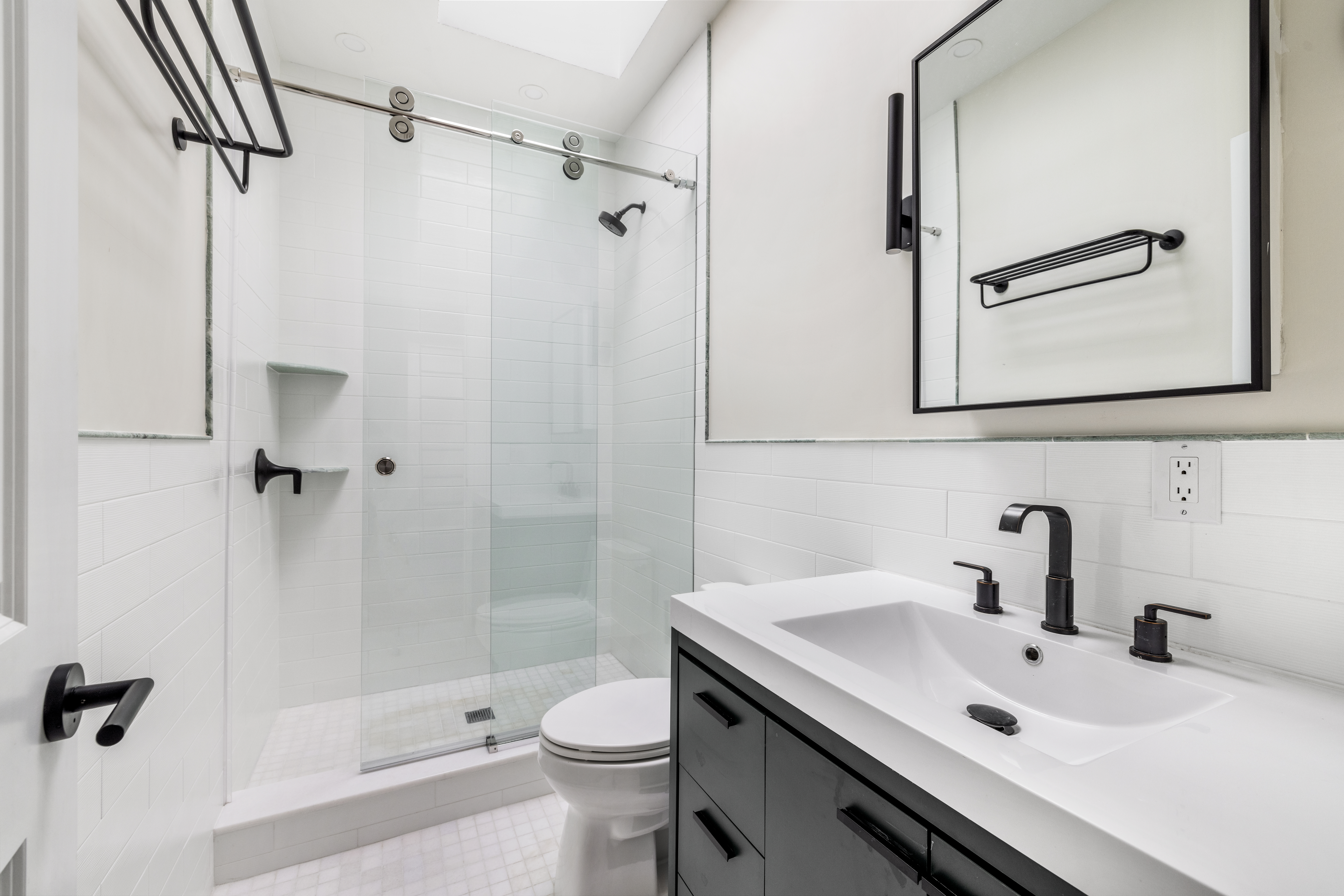 178 Sullivan Street, Unit 2A Manhattan, NY 10012 - Photo 6 of 19 a bathroom with a sink a toilet and a mirror