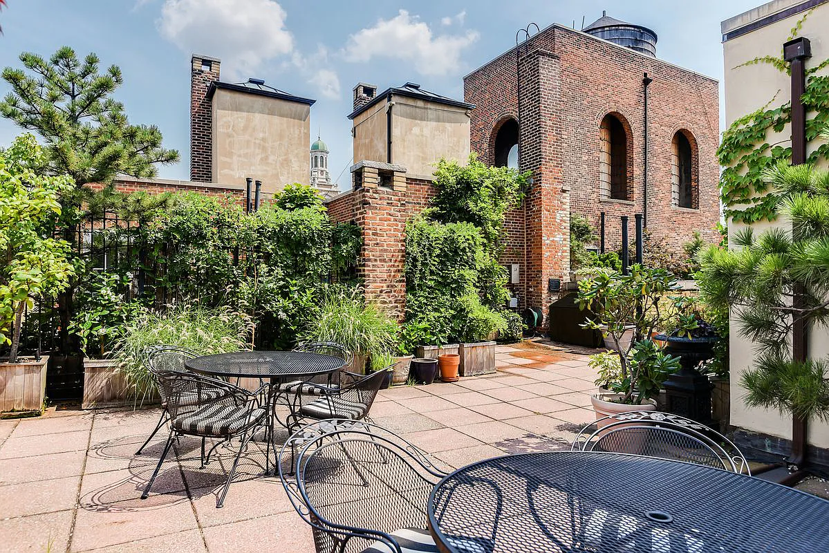 30 5th Avenue, Unit 3H Manhattan, NY 10011 - Photo 8 of 11 a patio with a table and chairs and potted plants
