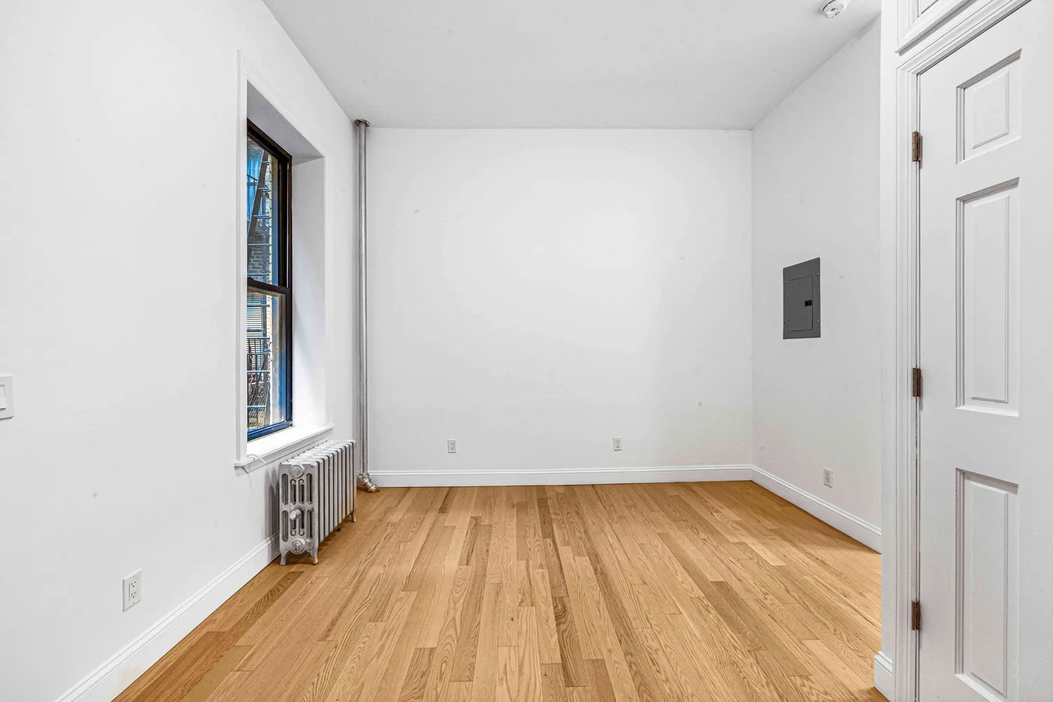 wooden floor in a room next to a window