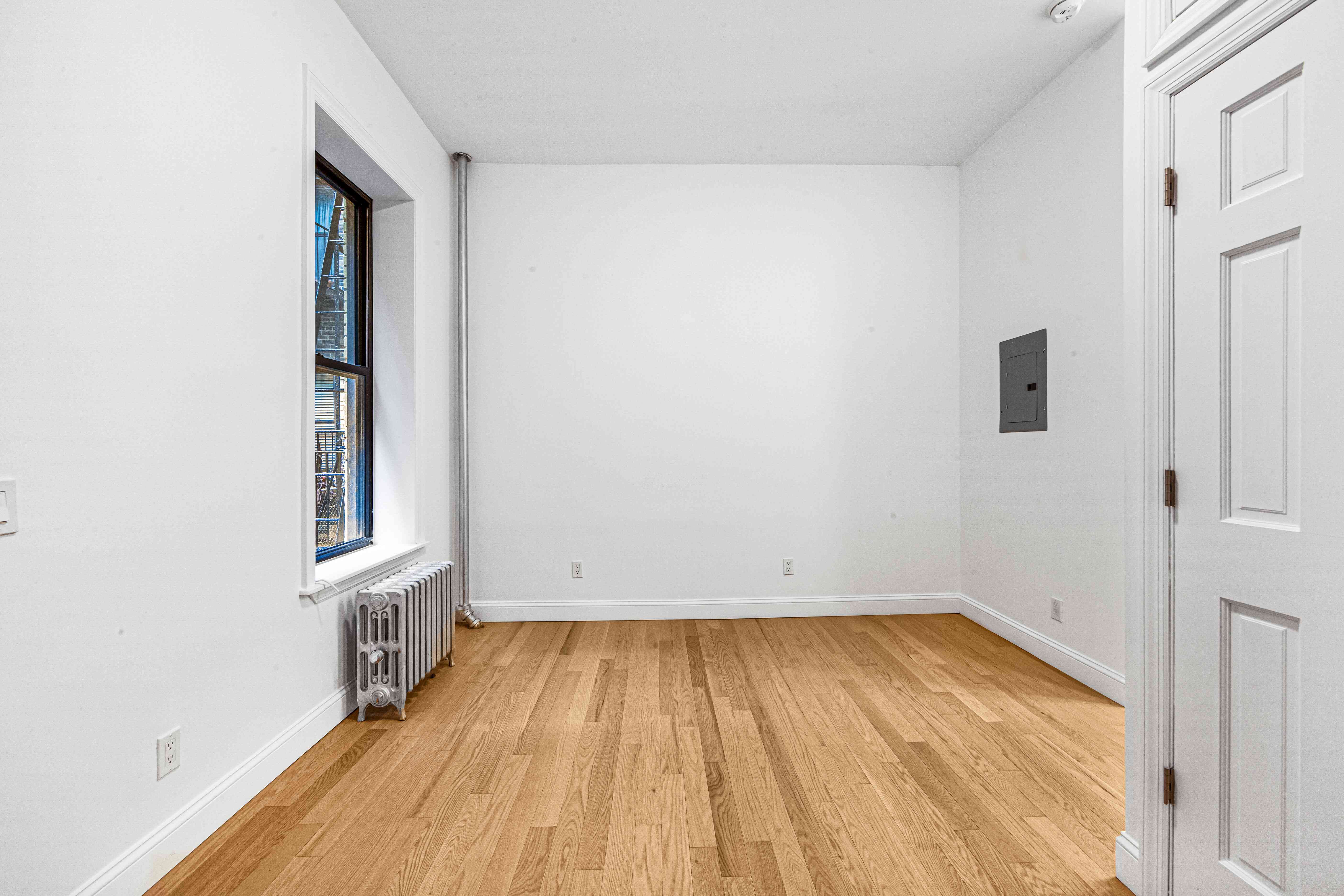 304 East 11th Street, Unit 1C Manhattan, NY 10003 - Photo 8 of 16 wooden floor in a room next to a window