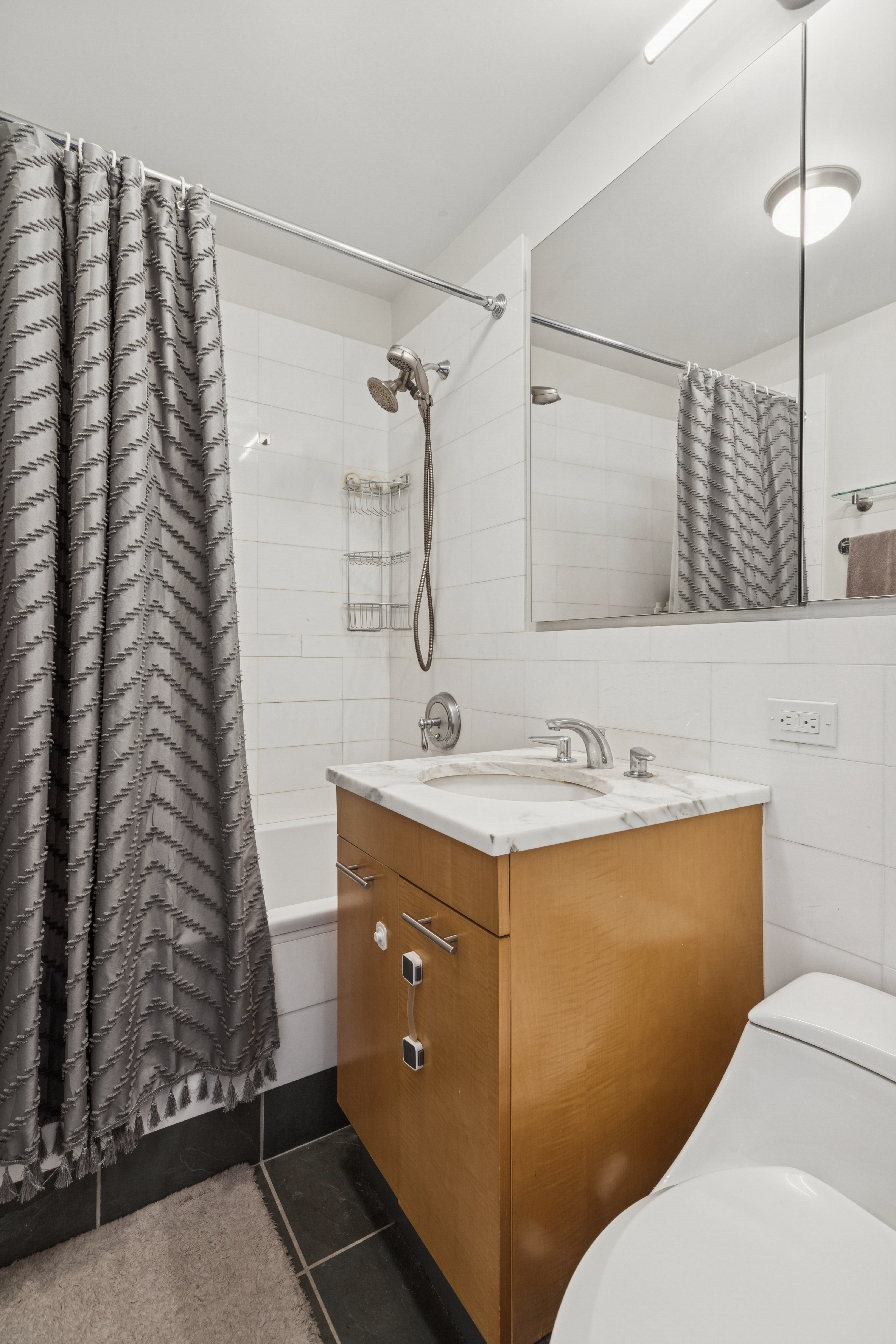 230 Ashland Place, Unit 22C Brooklyn, NY 11217 - Photo 8 of 13 a bathroom with a sink and a mirror