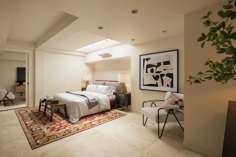 a bedroom with a large bed and a chandelier