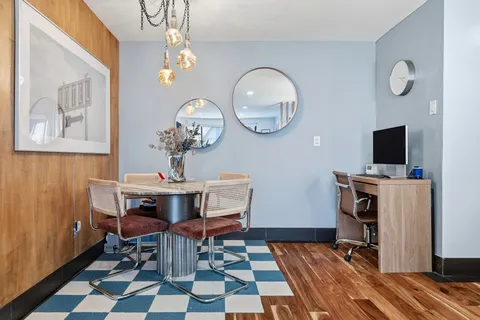 a view of a dining room with furniture and wooden floor