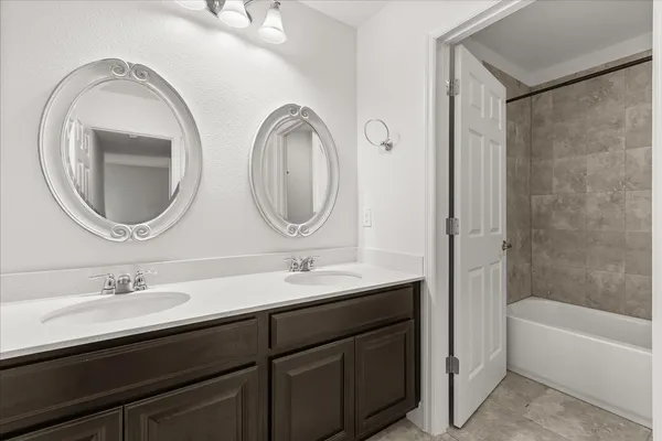 a utility room with wooden floor washer and dryer