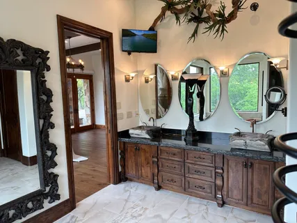 a bathroom with a granite countertop sink a toilet and mirror