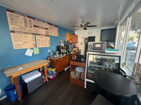 a living room with furniture a fireplace and a large window