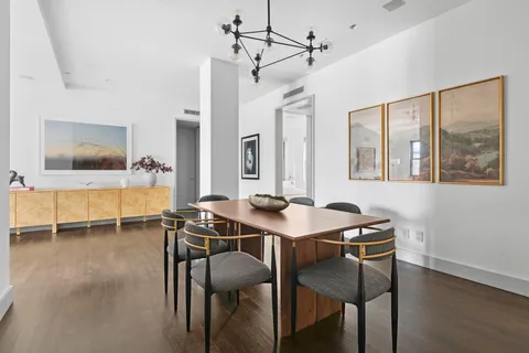 a view of a dining room with furniture and a chandelier