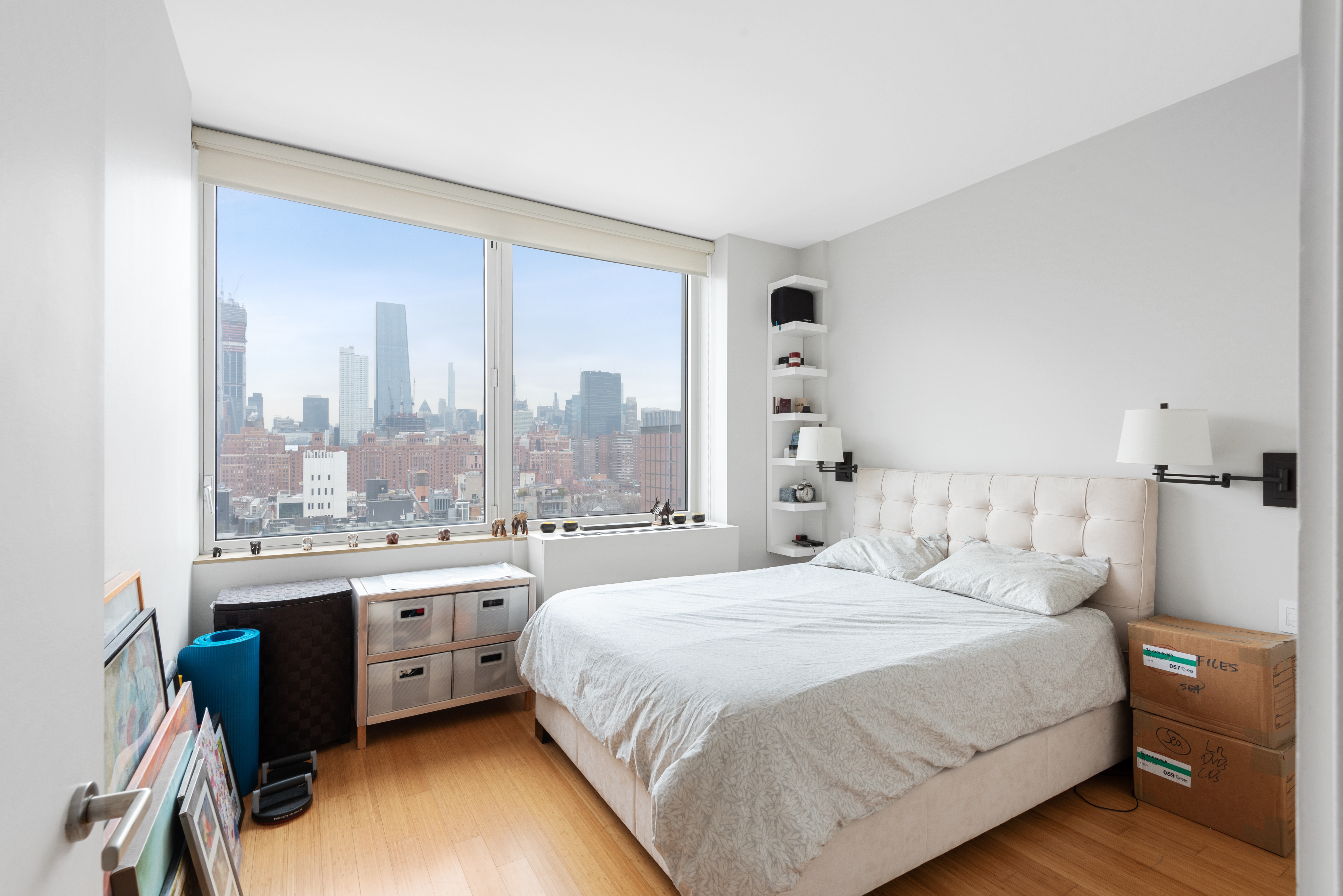 450 West 17th Street, Unit 1811 Manhattan, NY 10011 - Photo 6 of 14 a bedroom with a bed and a large window