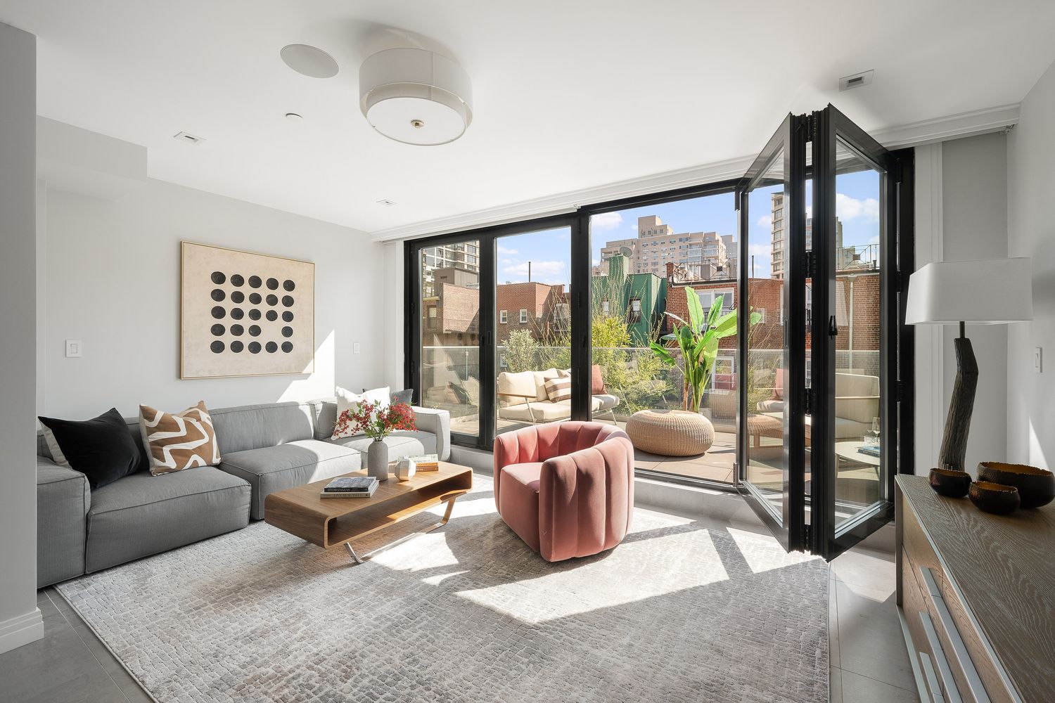 520 East 89th Street Manhattan, NY 10128 - Photo 12 of 40 a living room with furniture and a floor to ceiling window