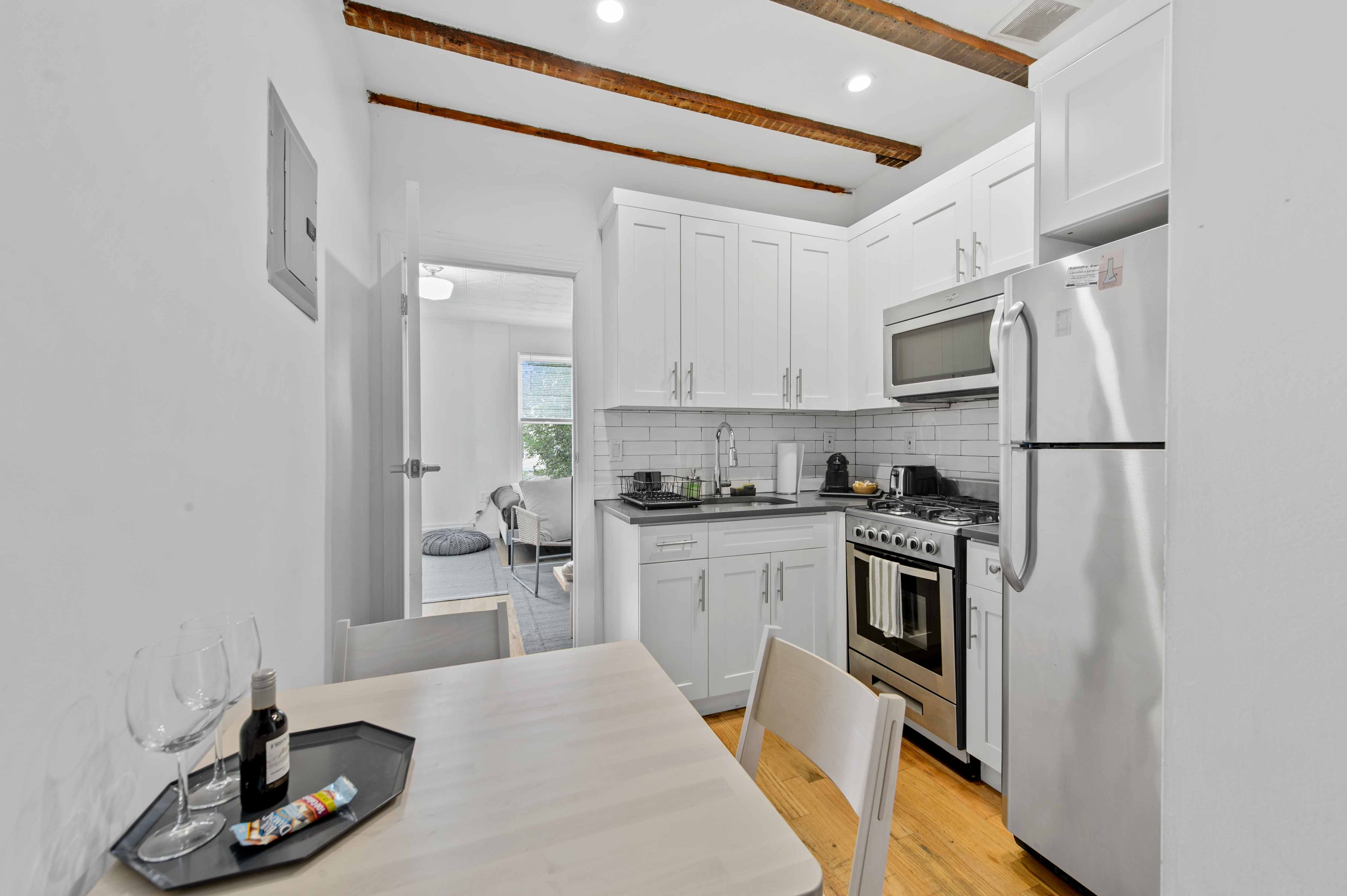 185 A Powers Street, Unit 1 Brooklyn, NY 11211 - Photo 3 of 13 a kitchen with white cabinets and appliances