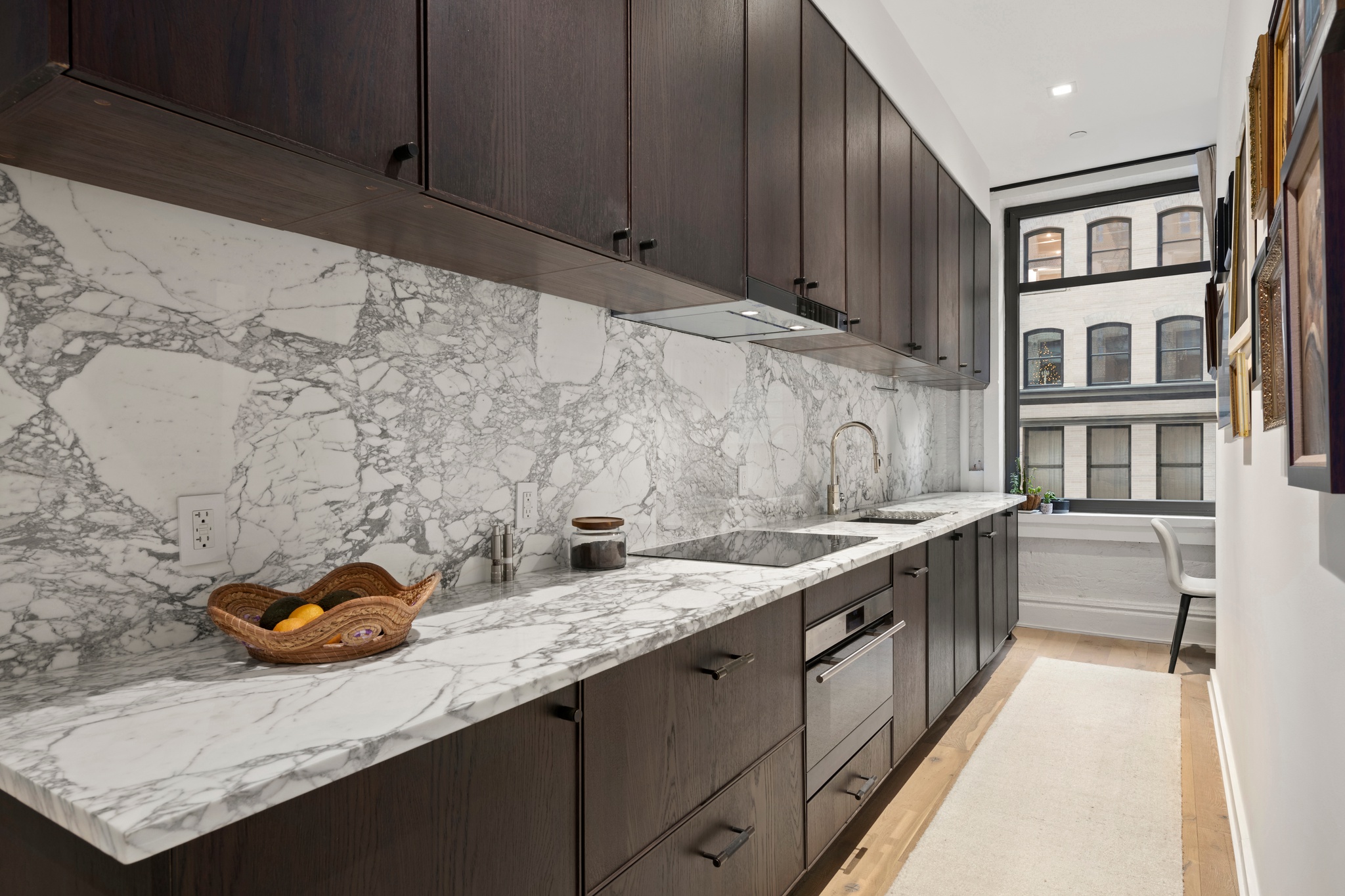 181 Hudson Street, Unit 2B Manhattan, NY 10013 - Photo 5 of 10 a kitchen with stainless steel appliances granite countertop a sink stove and cabinets