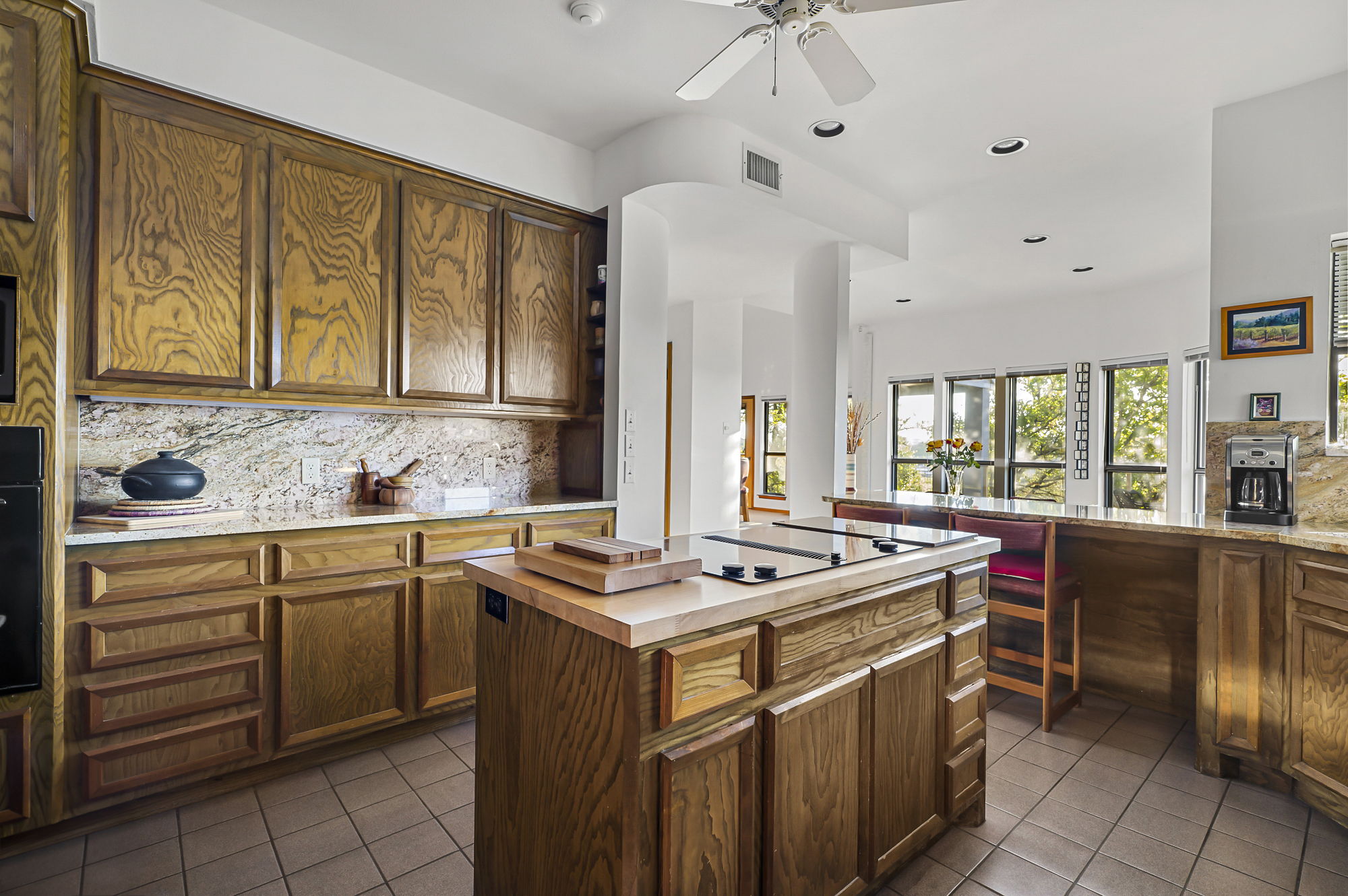1605 The High Road Austin, TX 78746 - Photo 12 of 45 a kitchen that has a stove and a table in it
