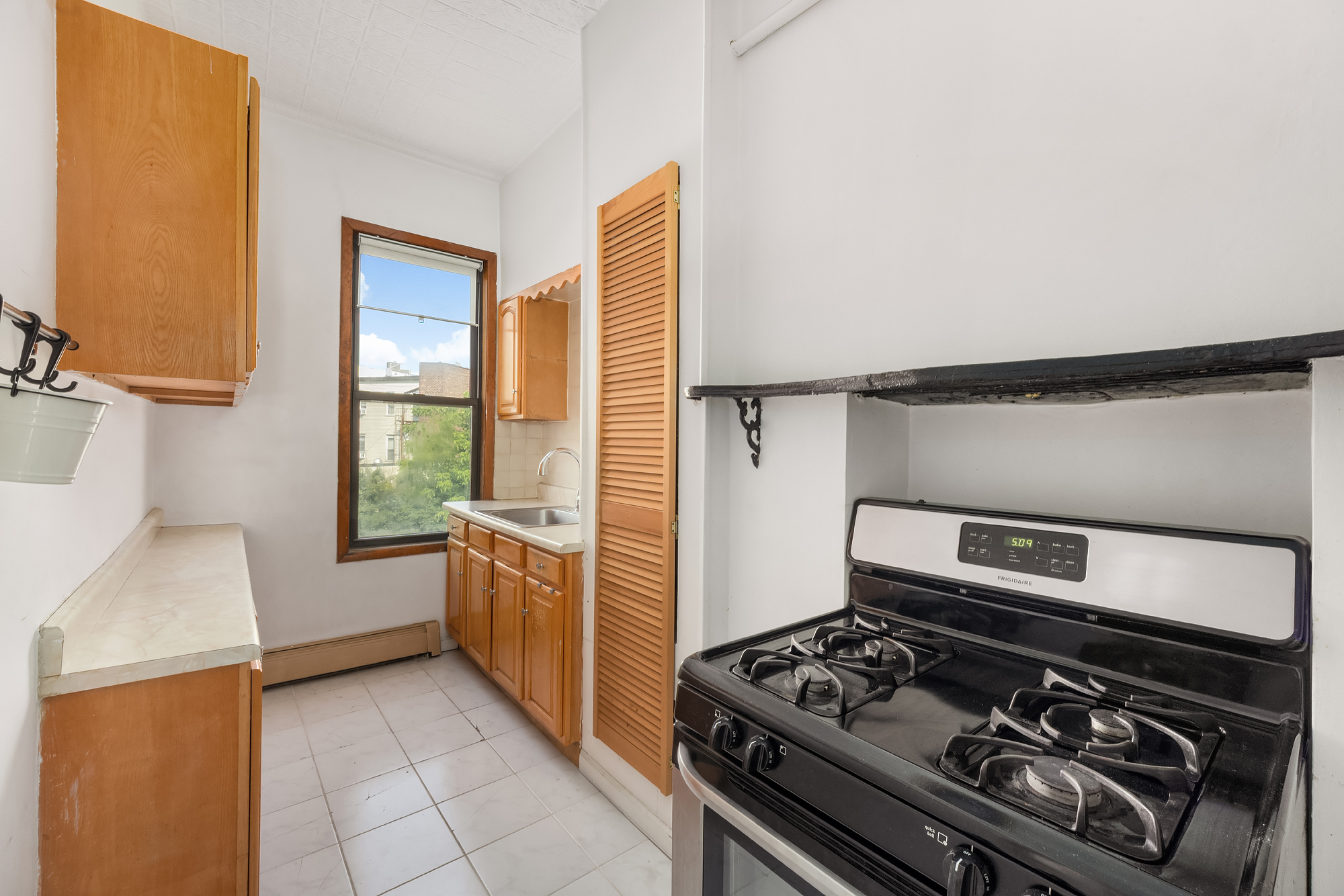 18 Russell Street Brooklyn, NY 11222 - Photo 21 of 24 a kitchen with a stove and a sink