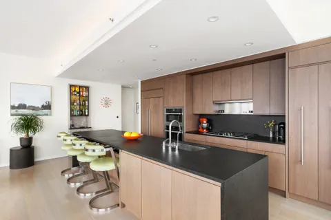a kitchen with a sink refrigerator and cabinets