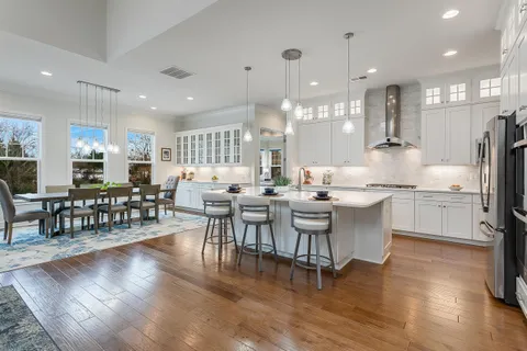 a kitchen with lots of counter top space and painting on the wall