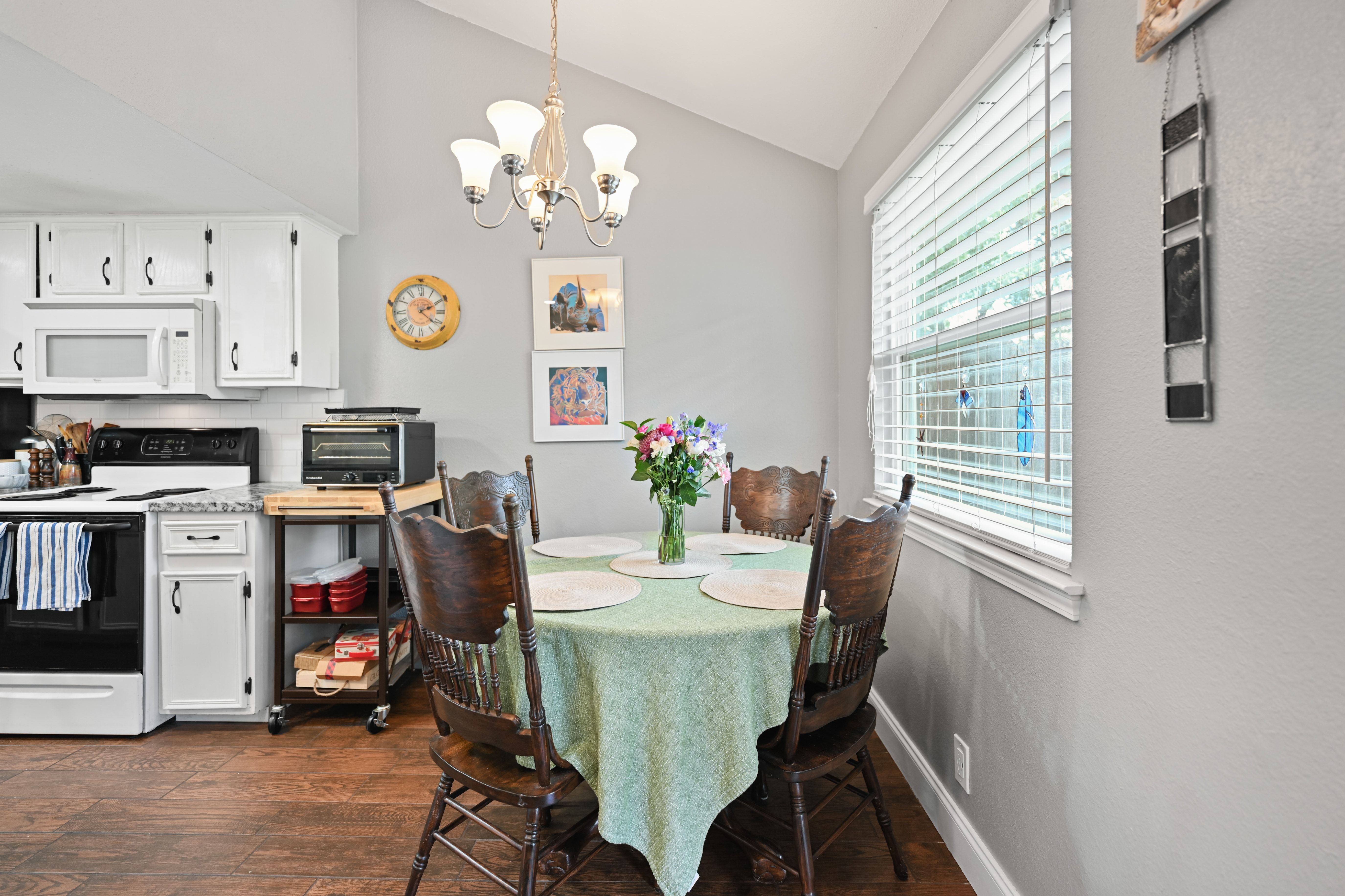 8710 Clearbrook Trail Austin, TX 78729 - Photo 6 of 28 a view of a dining room with furniture a chandelier and wooden floor