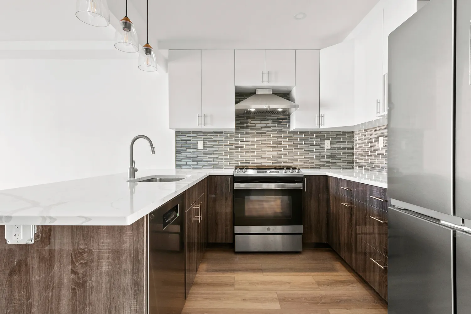 a kitchen with stainless steel appliances kitchen island granite countertop a sink a stove and cabinets