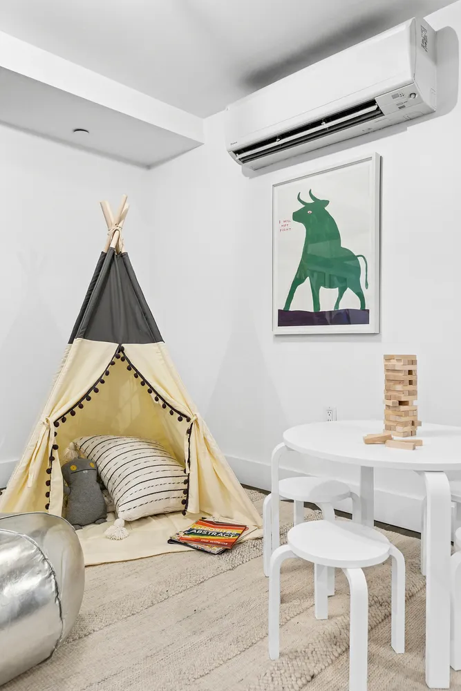 a living room with a bed and a painting on the wall