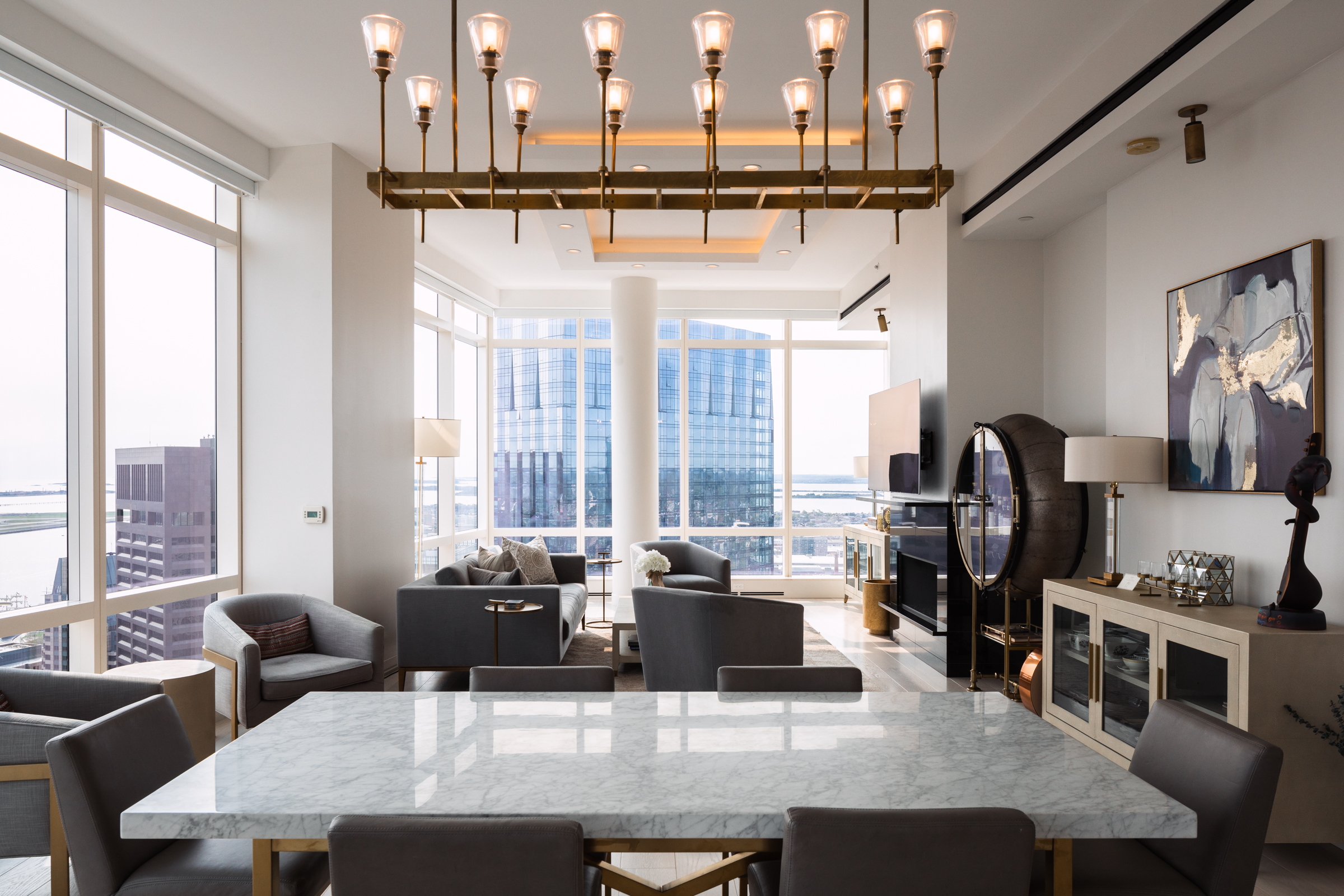 1 Franklin Street, Unit PH2D Boston, MA 02110 - Photo 3 of 26 a dining table with chairs and couches