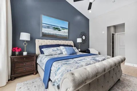 a bedroom with a bed and a chandelier