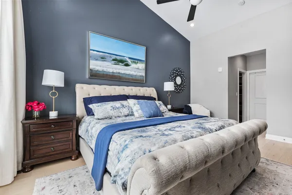 a bedroom with a bed and a chandelier