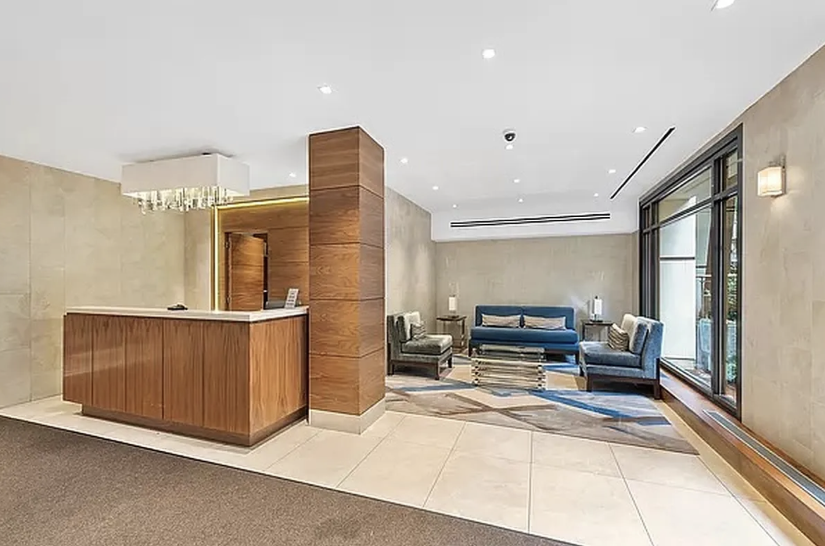 420 East 64th Street, Unit E7K Manhattan, NY 10065 - Photo 8 of 10 a living room with furniture and a fireplace