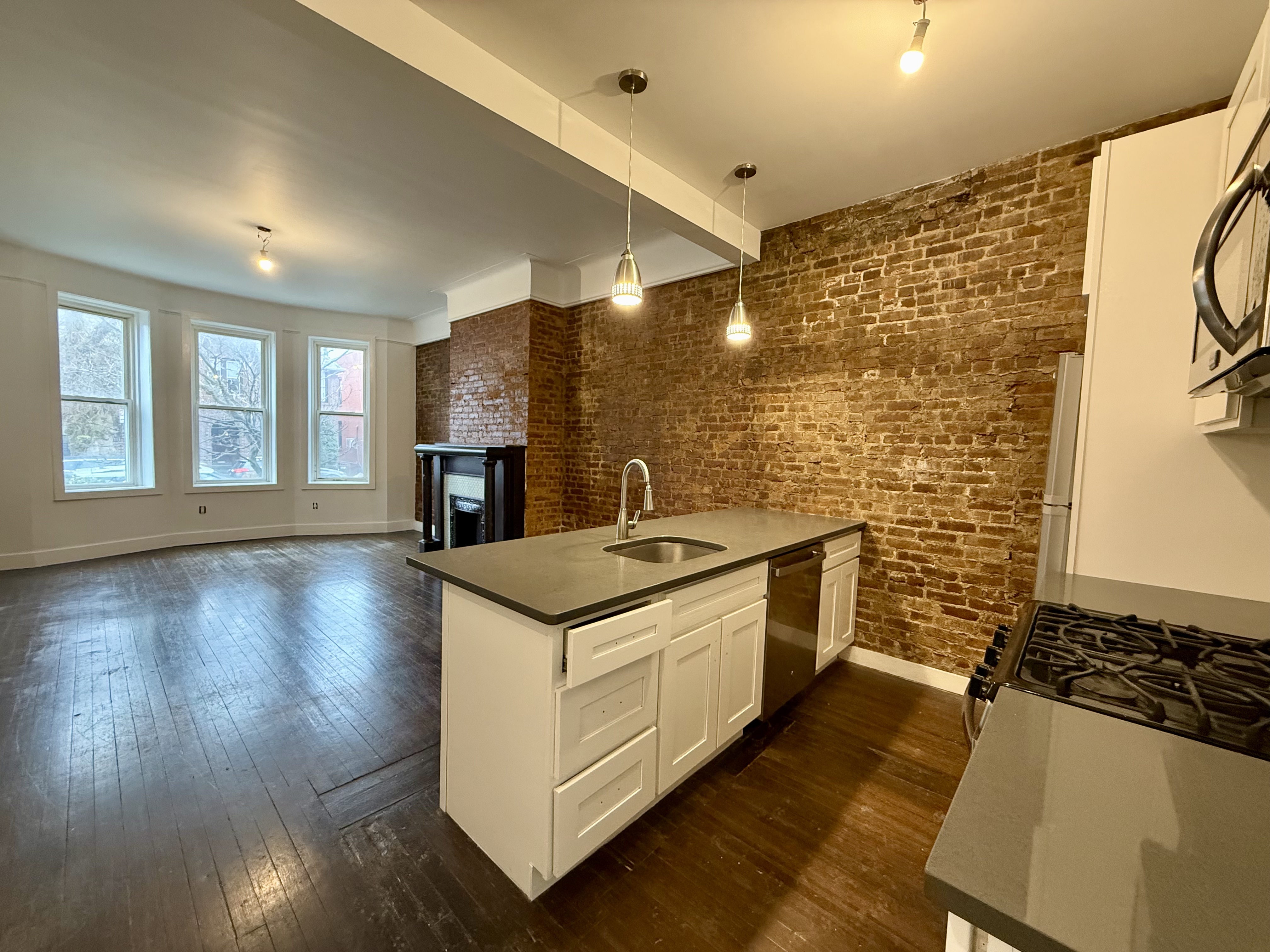 249 94th Street, Unit 1 Brooklyn, NY 11209 - Photo 4 of 13 a kitchen with sink stove and cabinets