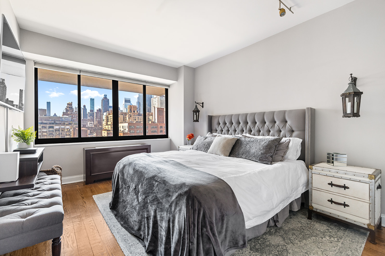 350 East 72nd Street, Unit 12A Manhattan, NY 10021 - Photo 4 of 9 a bedroom with a bed and a large window