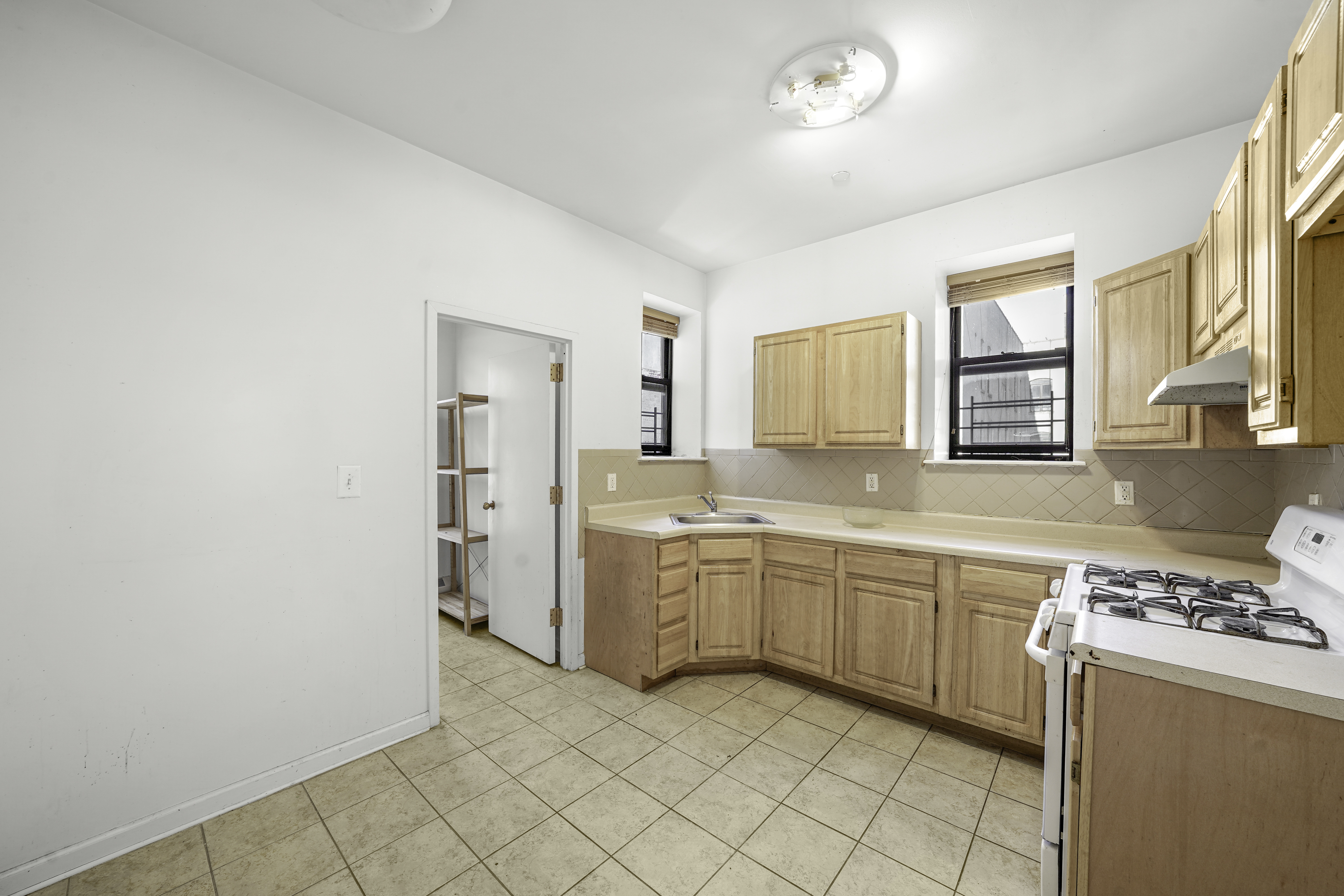 163 Lenox Avenue, Unit 5A Manhattan, NY 10026 - Photo 11 of 16 a large kitchen with a stove a sink dishwasher and a refrigerator