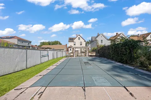 a view of a house with backyard and porch with furniture