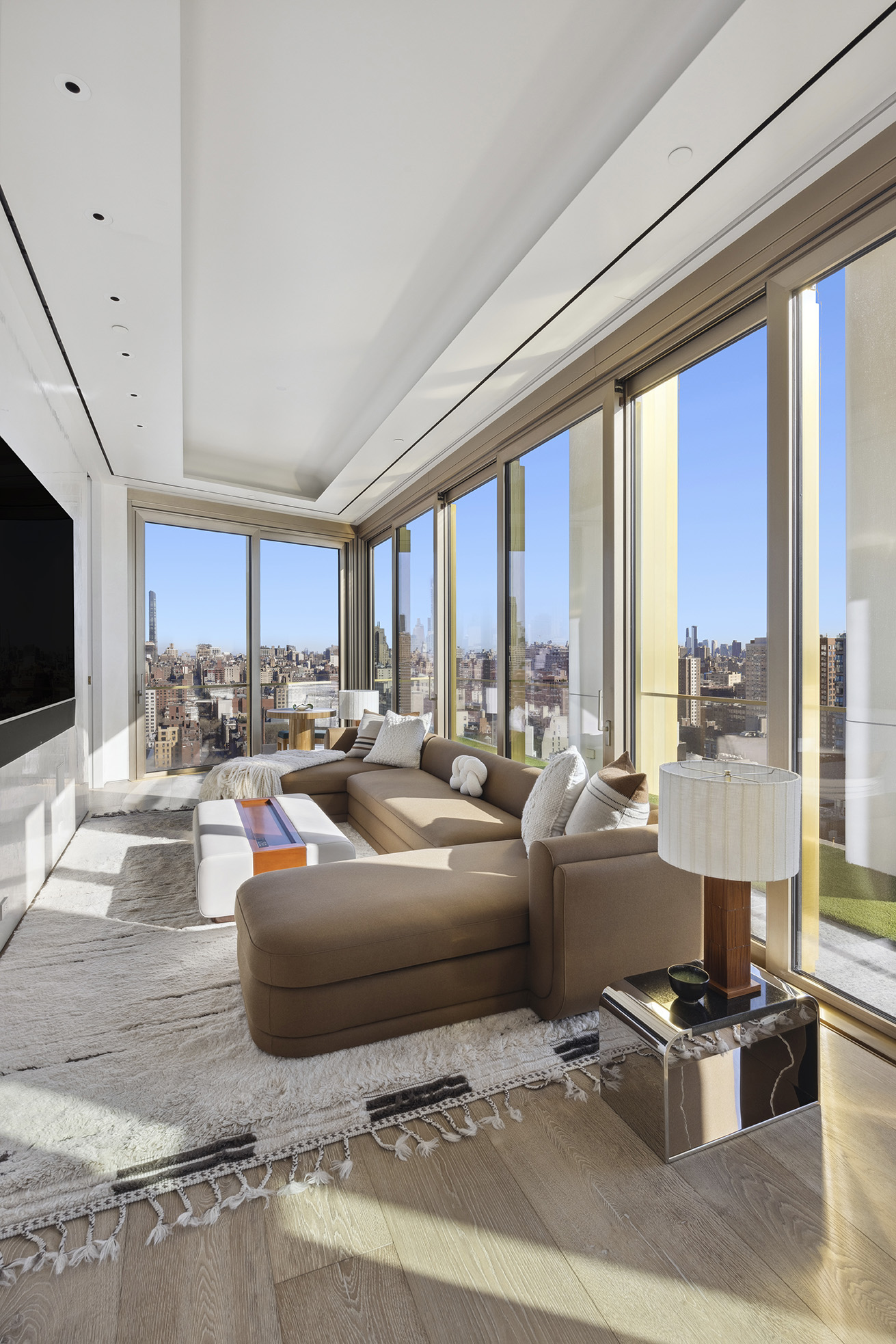 551 West 21st Street, Unit PH Manhattan, NY 10011 - Photo 33 of 51 a living room with furniture a large window and a flat screen tv