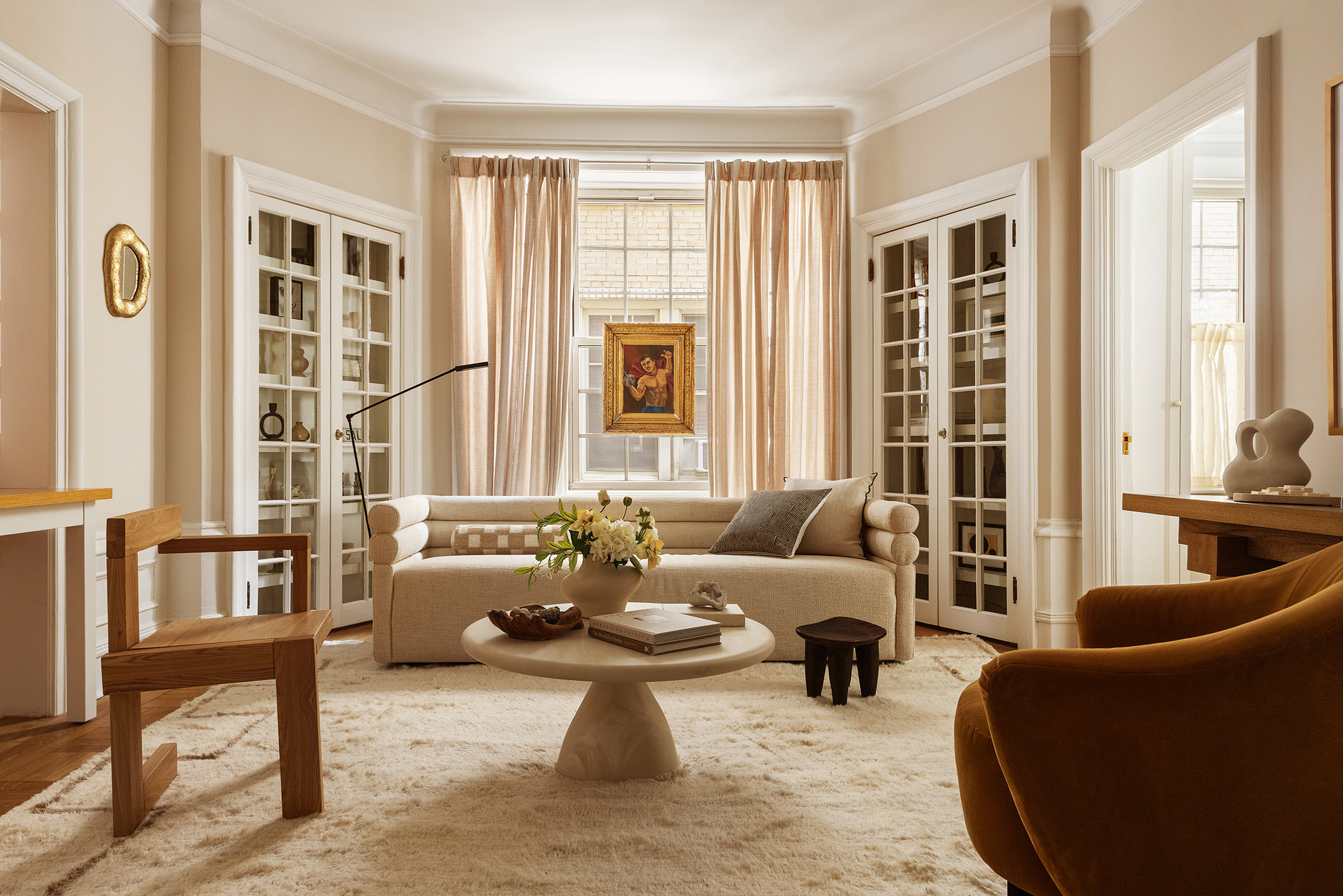 a living room with furniture and floor to ceiling windows