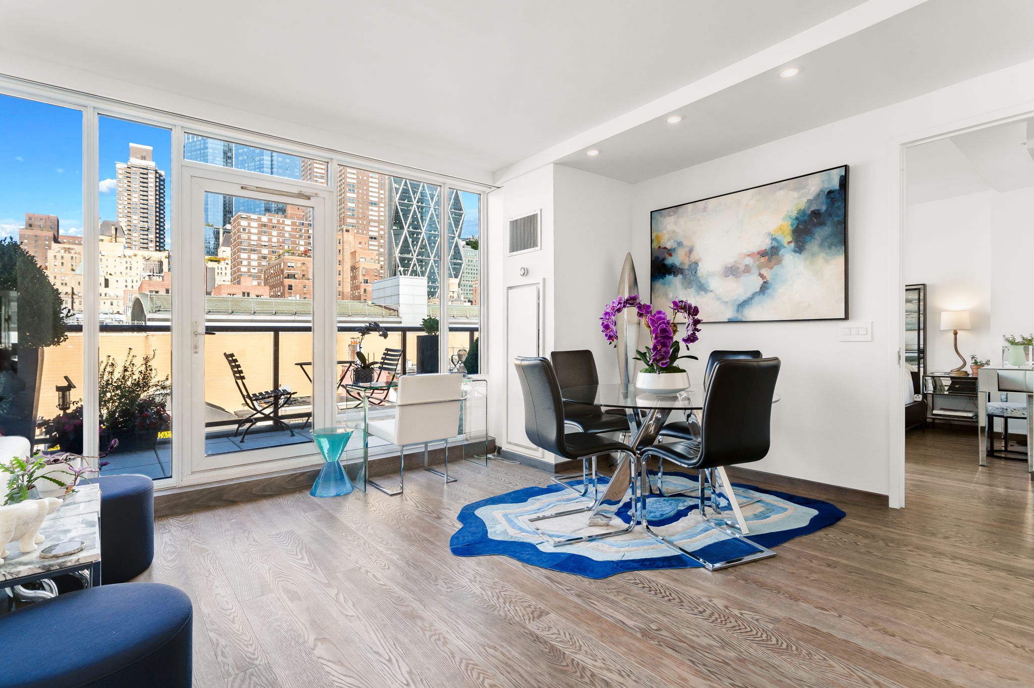 350 West 53rd Street, Unit PHB Manhattan, NY 10019 - Photo 4 of 34 a living room with furniture and a dining table with wooden floor