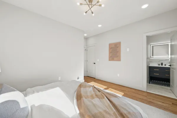 a bedroom with a bed and a ceiling fan