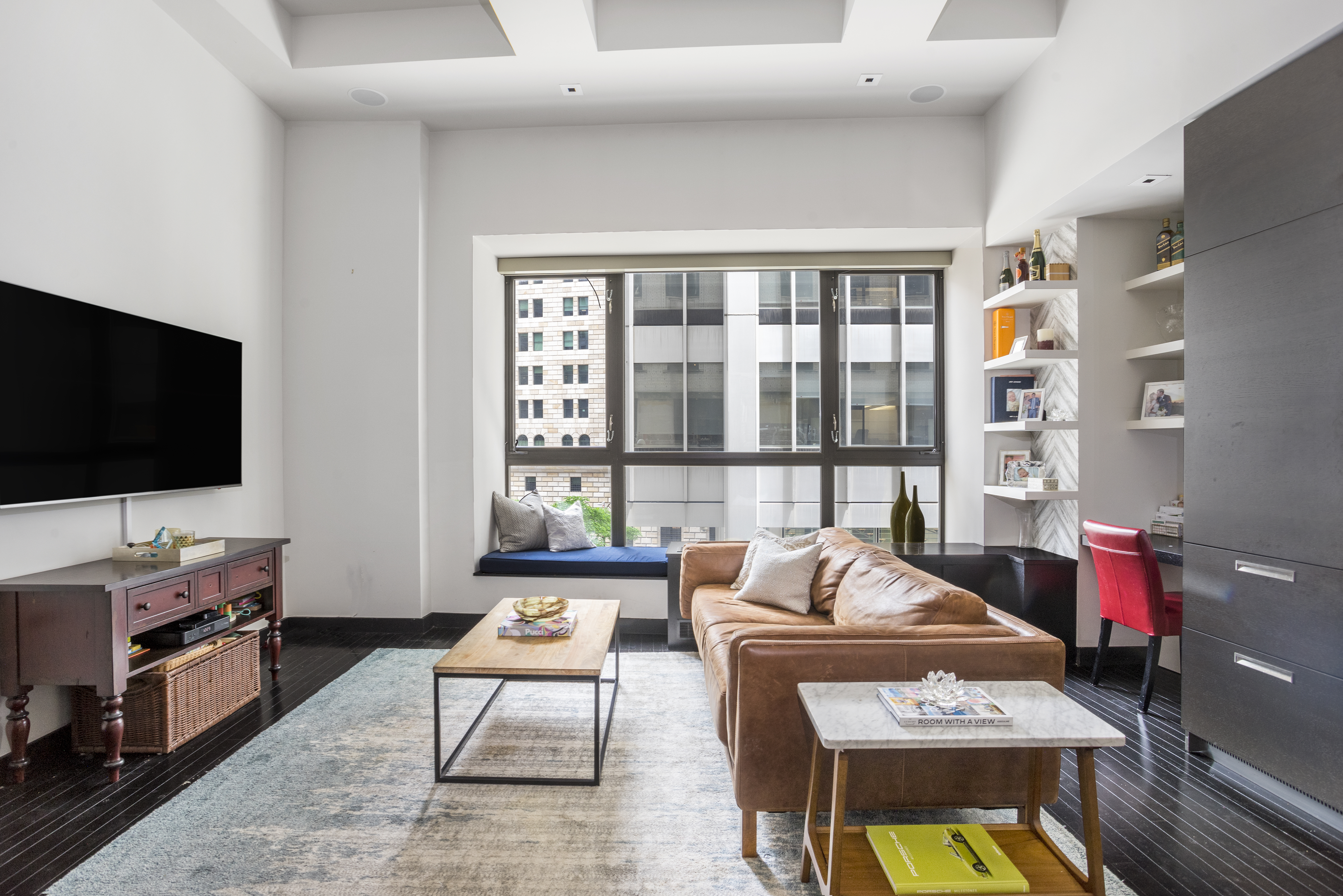 20 Pine Street, Unit 409 Manhattan, NY 10005 - Photo 3 of 11 a living room with furniture and a flat screen tv